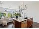 Kitchen island leading to living area with couch, open layout, and modern décor at 7240 W Custer Ave # 303, Lakewood, CO 80226