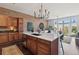 Kitchen island view to the living area with brick wall, open-concept design, and modern finishes at 7240 W Custer Ave # 303, Lakewood, CO 80226