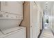 Efficient laundry area with stacked washer and dryer, conveniently located in the hallway at 7240 W Custer Ave # 303, Lakewood, CO 80226