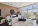 Living room featuring exposed brick wall, large windows, stylish decor, and comfortable seating at 7240 W Custer Ave # 303, Lakewood, CO 80226