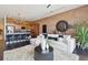Open concept living area with modern furnishings, exposed brick, and hardwood floors at 7240 W Custer Ave # 303, Lakewood, CO 80226