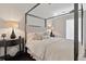 Relaxing bedroom with a sleek four-poster bed, decorative lamps, and minimalist decor at 7240 W Custer Ave # 303, Lakewood, CO 80226