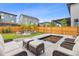 Backyard featuring a cozy outdoor fire pit, water feature and relaxing lounge chairs at 14423 Shasta Daisy Ln, Parker, CO 80134