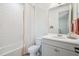 Bright bathroom featuring a tub/shower combo, colorful shower curtain, and gray vanity at 14423 Shasta Daisy Ln, Parker, CO 80134