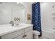 Bright bathroom featuring a tub/shower combo, fun shower curtain, and gray vanity at 14423 Shasta Daisy Ln, Parker, CO 80134