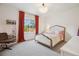 Well-lit bedroom featuring a white bed, colorful curtains, and a bookcase at 14423 Shasta Daisy Ln, Parker, CO 80134