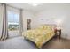 Charming bedroom with a sunflower patterned bedspread and bookshelf next to a large window at 14423 Shasta Daisy Ln, Parker, CO 80134
