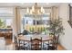 Bright dining room with modern chandelier and sliding glass doors to the backyard at 14423 Shasta Daisy Ln, Parker, CO 80134
