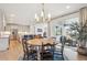 Open-concept dining area leads to the kitchen, living room, and backyard at 14423 Shasta Daisy Ln, Parker, CO 80134