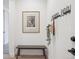 A minimalist entryway with a bench, art, and coat hooks offering both style and functionality at 14423 Shasta Daisy Ln, Parker, CO 80134