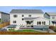 Rear view of the home showing the covered patio with an outdoor dining set, plunge pool, and fire pit seating area at 14423 Shasta Daisy Ln, Parker, CO 80134