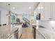 Bright kitchen with an island overlooking the dining area and staircase to the second floor at 14423 Shasta Daisy Ln, Parker, CO 80134