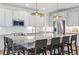 Modern kitchen featuring stainless steel appliances and a large center island with barstool seating at 14423 Shasta Daisy Ln, Parker, CO 80134