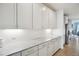 Bright kitchen featuring white cabinets, granite countertops, and gold hardware at 14423 Shasta Daisy Ln, Parker, CO 80134