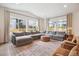 A spacious living room with large windows and comfortable seating area at 14423 Shasta Daisy Ln, Parker, CO 80134
