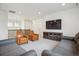 Living room featuring couches, chairs, TV, and an overlooking view to the entry way at 14423 Shasta Daisy Ln, Parker, CO 80134