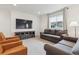 Spacious living room with comfortable seating, TV, and a view from the window at 14423 Shasta Daisy Ln, Parker, CO 80134