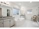 Bright main bathroom with double vanity, bathtub, and tiled walk-in shower at 14423 Shasta Daisy Ln, Parker, CO 80134