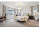 Spacious main bedroom featuring a chandelier, large windows, and a seating area at 14423 Shasta Daisy Ln, Parker, CO 80134