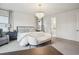 Beautiful bedroom with a chandelier, comfortable bed, and an open doorway to a bathroom at 14423 Shasta Daisy Ln, Parker, CO 80134