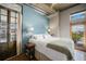 Bright bedroom with ensuite balcony access, industrial-chic decor, and a cozy modern aesthetic at 1925 W 32Nd Ave # 404, Denver, CO 80211