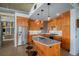 Modern kitchen features custom wood cabinets, stainless steel appliances and a large island with bar stool seating at 1925 W 32Nd Ave # 404, Denver, CO 80211