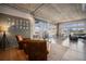 Open living room area with hardwood flooring, many windows, and exposed concrete ceiling at 1925 W 32Nd Ave # 404, Denver, CO 80211