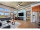 Open living area featuring hardwood floors, a modern ceiling fan, and large windows at 1925 W 32Nd Ave # 404, Denver, CO 80211