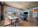Open concept area featuring hardwood floors, exposed concrete ceiling, and a dining area at 1925 W 32Nd Ave # 404, Denver, CO 80211