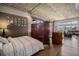 Spacious main bedroom with exposed concrete ceiling, hardwood floors, and multiple windows for natural light at 1925 W 32Nd Ave # 404, Denver, CO 80211