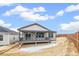 Home exterior showcasing a deck with a covered porch and a wooden fence at 4323 Soapberry Pl, Castle Rock, CO 80108