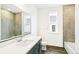 Modern bathroom showcasing a single sink vanity, framed mirror, and tiled shower and tub at 4323 Soapberry Pl, Castle Rock, CO 80108