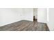 Bright bedroom features wood-look floors and neutral walls with doorways leading to a walk-in closet and attached bathroom at 4323 Soapberry Pl, Castle Rock, CO 80108