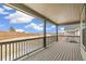 Relaxing covered deck with wood floors overlooks the backyard and expansive views at 4323 Soapberry Pl, Castle Rock, CO 80108