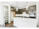 Stylish kitchen featuring dark cabinets, white quartz countertops, pendant lighting, and stainless steel appliances at 4323 Soapberry Pl, Castle Rock, CO 80108