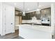 Kitchen featuring dark cabinets, quartz countertops, stainless steel appliances, and an island with pendant lights at 4323 Soapberry Pl, Castle Rock, CO 80108