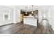 Modern kitchen featuring dark cabinets, a white island with quartz countertops, and stainless steel appliances at 4323 Soapberry Pl, Castle Rock, CO 80108