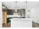 Modern kitchen with dark cabinets, stainless steel appliances, pendant lights, and a center island with quartz countertops at 4323 Soapberry Pl, Castle Rock, CO 80108