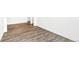 Bright living room with wood-look flooring, white walls, and ample natural light at 4323 Soapberry Pl, Castle Rock, CO 80108