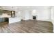 Open-concept living area featuring wood-look flooring and modern gas fireplace at 4323 Soapberry Pl, Castle Rock, CO 80108