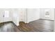 Bright living room with wood-look flooring, white walls, and ample natural light at 4323 Soapberry Pl, Castle Rock, CO 80108