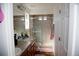 Well-lit bathroom featuring a double sink vanity and a glass-enclosed shower at 2848 Merry Rest Way, Castle Rock, CO 80109