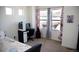 Cozy bedroom featuring natural light, neutral carpet, and a dedicated computer desk area at 2848 Merry Rest Way, Castle Rock, CO 80109