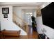 Light-filled entrance featuring hardwood floors, modern decor, and a staircase at 2848 Merry Rest Way, Castle Rock, CO 80109