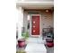 Inviting front porch with a stylish red door, potted plants, and a welcome mat at 2848 Merry Rest Way, Castle Rock, CO 80109