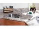 Close-up of kitchen sink with granite countertop, stainless steel faucet, and dish rack at 2848 Merry Rest Way, Castle Rock, CO 80109