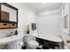 Bathroom featuring a clawfoot tub, black and white tile floor, pedestal sink, and wainscoting at 1475 N Humboldt St # 20, Denver, CO 80218
