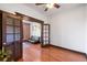 Living room features hardwood floors, dark trim, glass pocket doors, brick accent wall, and a black futon couch at 1475 N Humboldt St # 20, Denver, CO 80218