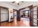 Inviting living room with hardwood floors, dark trim, pocket doors leading to the brick accent wall, and a closet at 1475 N Humboldt St # 20, Denver, CO 80218
