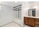 Bathroom featuring a tiled shower and a vanity with storage at 4010 Grove St, Denver, CO 80211